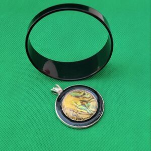 Vintage Monet Paint Spill Pendant and black bracelet.
